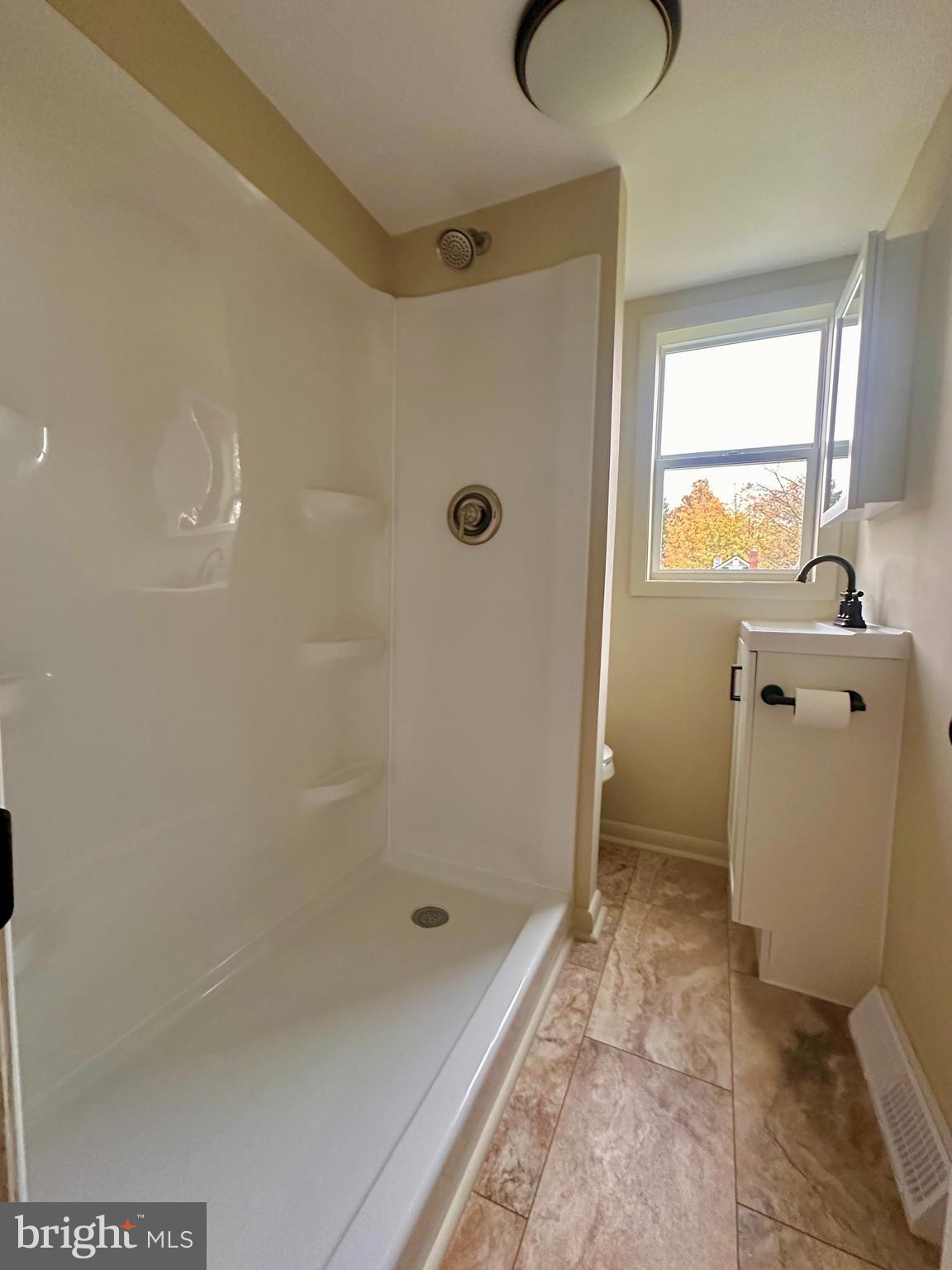 7488 Dusty Road Mercersburg, PA 17236 - Photo 16 of 27 a bathroom with a granite countertop sink a toilet and shower