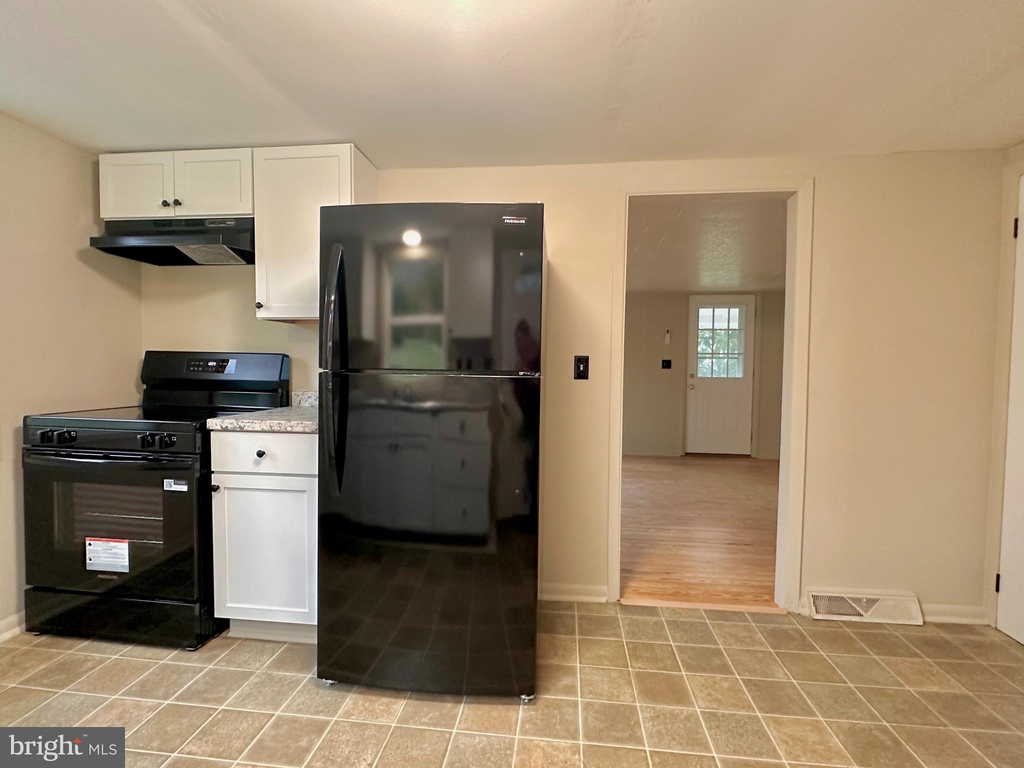 7488 Dusty Road Mercersburg, PA 17236 - Photo 8 of 27 a kitchen with a refrigerator and a stove top oven