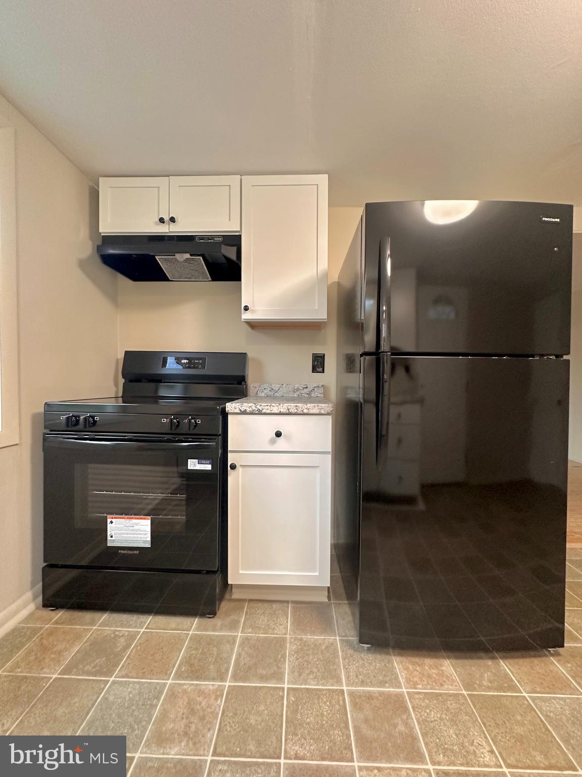 7488 Dusty Road Mercersburg, PA 17236 - Photo 9 of 27 a kitchen with a stove and a refrigerator