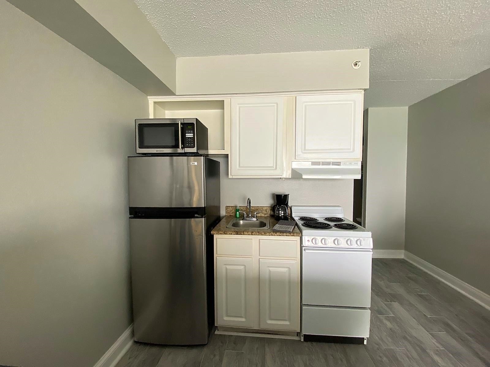 1207 South Ocean Boulevard, Unit 20809 Myrtle Beach, SC 29577 - Photo 10 of 19 Kitchen featuring sink, stainless steel appliances, dark hardwood / wood-style floors, and white cabinets