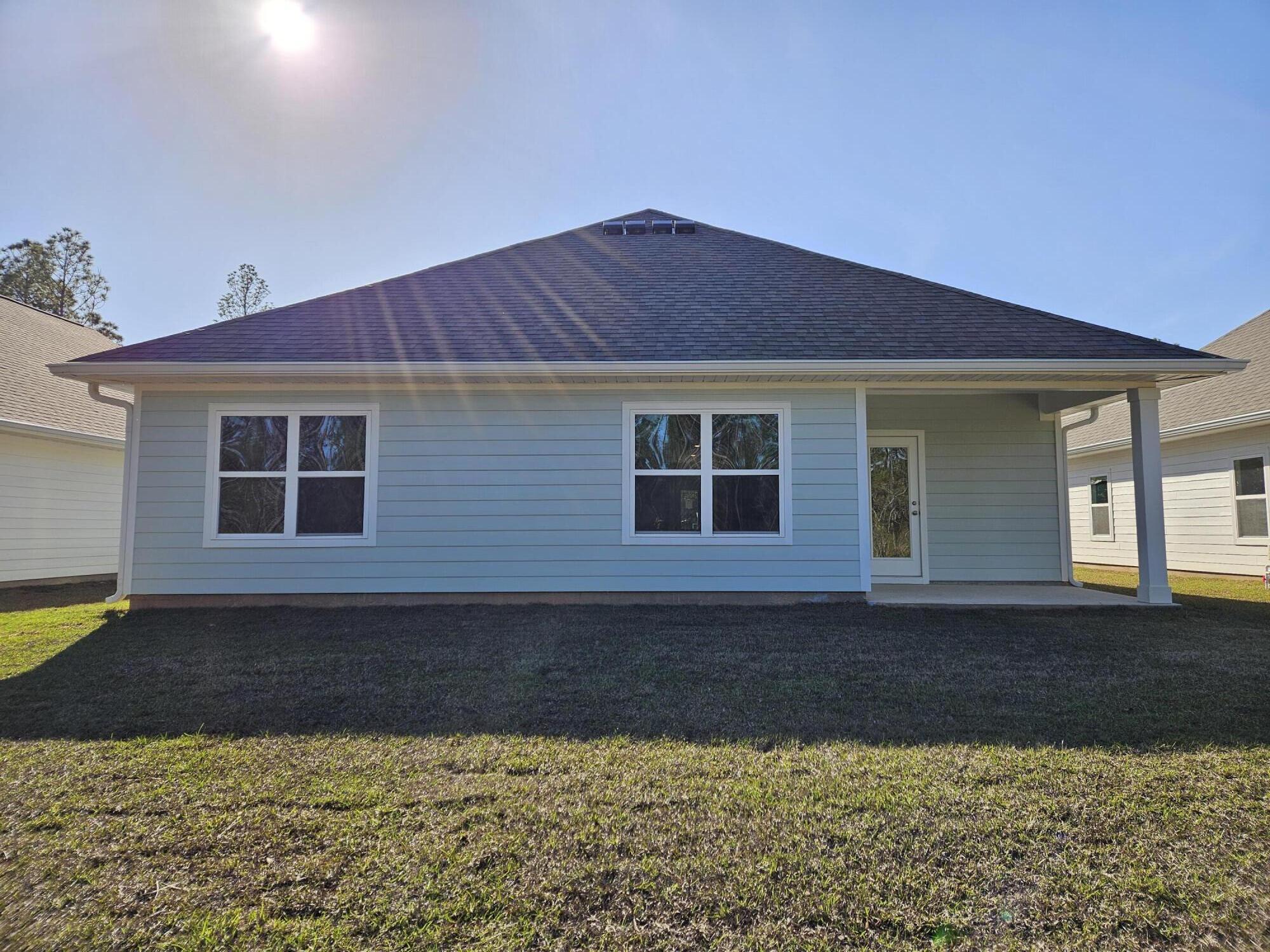 7 Nest Lane Santa Rosa Beach, FL 32459 - Photo 16 of 16 a front view of a house with a yard and garage