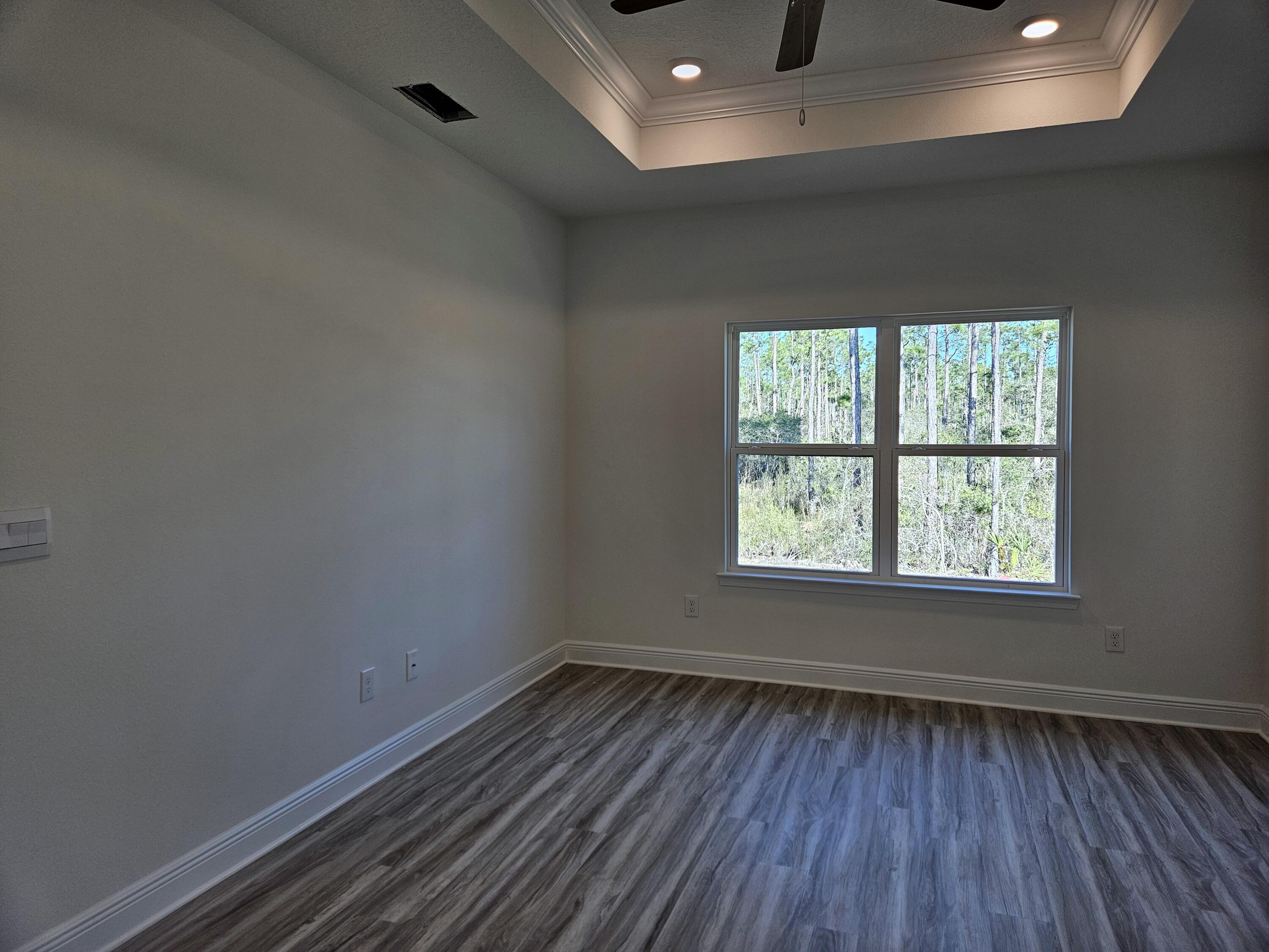 7 Nest Lane Santa Rosa Beach, FL 32459 - Photo 8 of 16 an empty room with wooden floor and windows