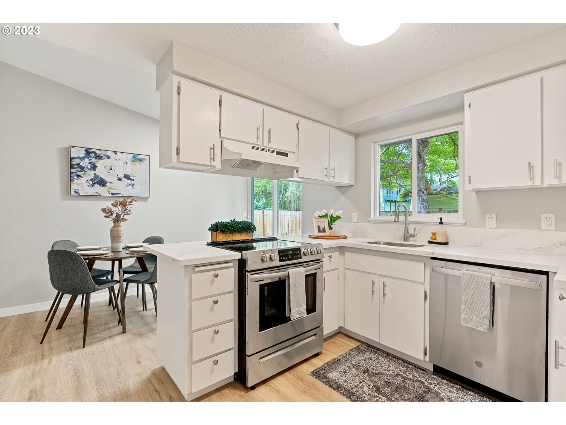 5830 Southwest 177th Avenue Beaverton, OR 97007 - Photo 16 of 41 a kitchen with a stove a sink and white cabinets