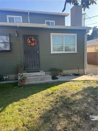 a view of a house with a yard