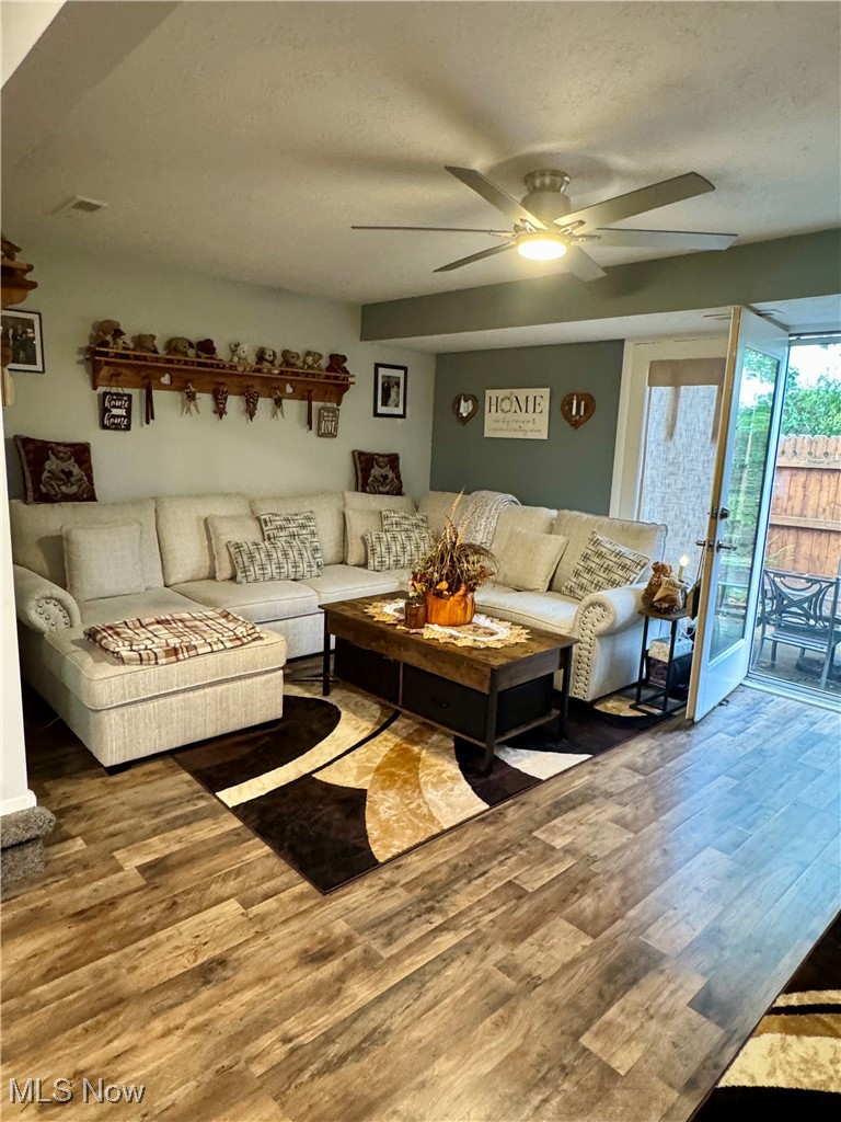 8949 West Ridge Road, Unit B Elyria, OH 44035 - Photo 15 of 24 Living area with wood finished floors, a textured ceiling, and a ceiling fan