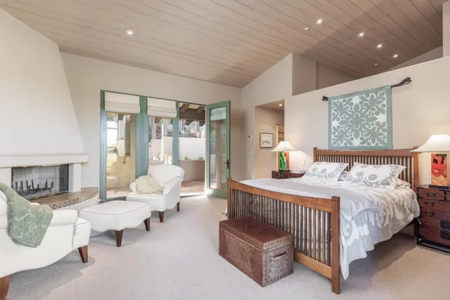 a bedroom with a bed and large window