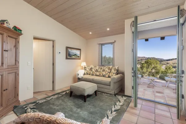 a living room with furniture and a floor to ceiling window