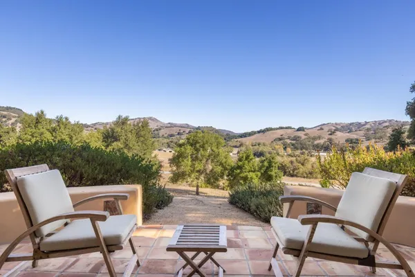 a view of a chairs and table in patio