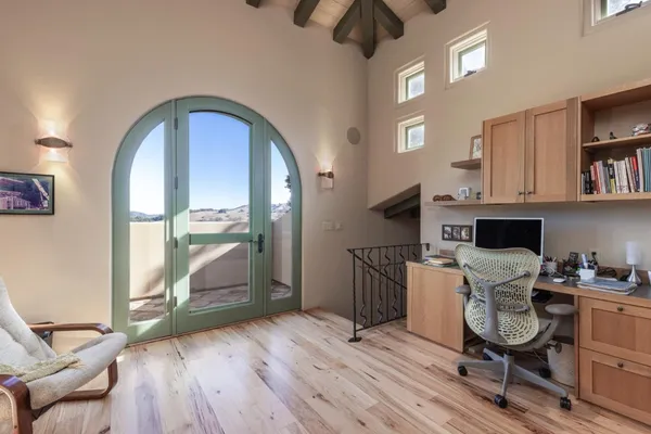 a workspace with a wooden floor and a window