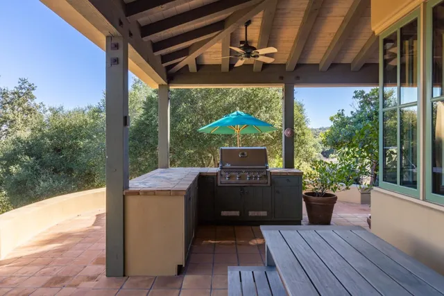 a view of a balcony with furniture and wooden floor