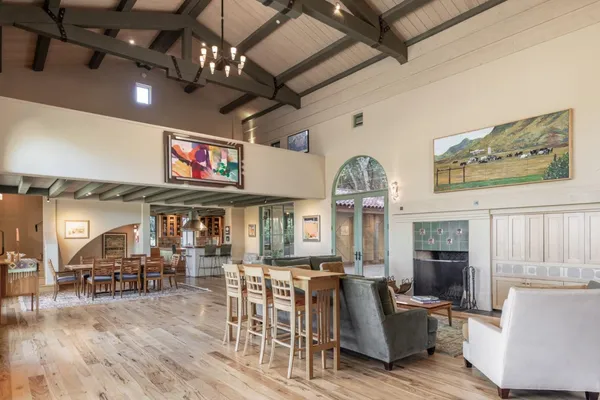 a view of a livingroom with furniture a flat screen tv and couches