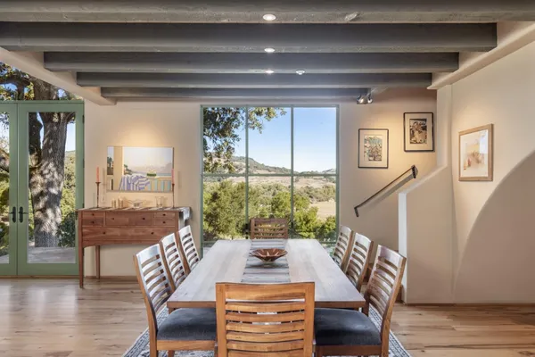 a view of a dining room with furniture window and wooden floor