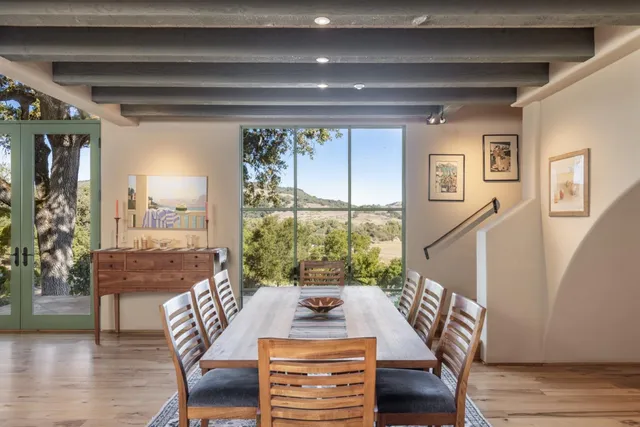 a view of a dining room with furniture window and wooden floor