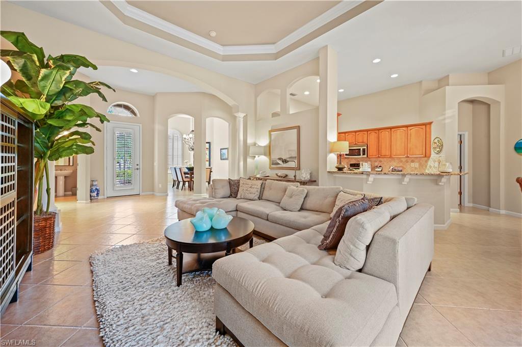 7950 Founders Circle Naples, FL 34104 - Photo 15 of 43 a living room with furniture a chandelier and a dining table