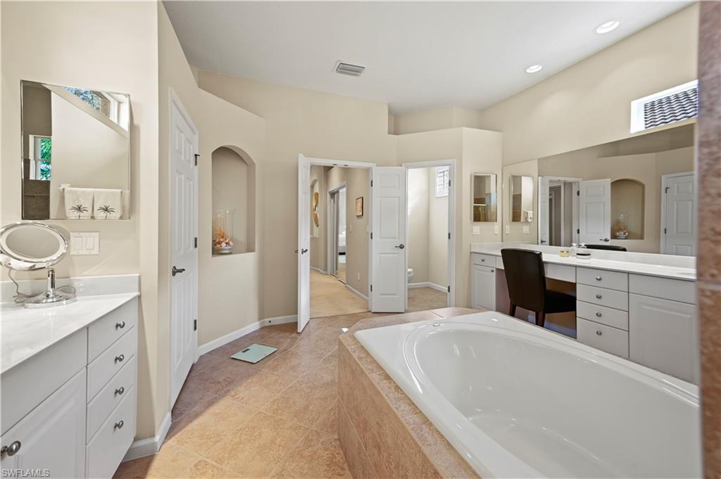 7950 Founders Circle Naples, FL 34104 - Photo 18 of 43 a spacious bathroom with a tub sink shower and mirror