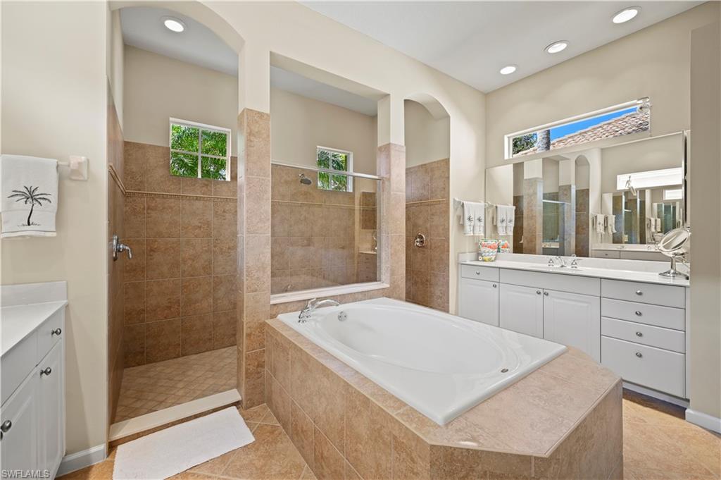7950 Founders Circle Naples, FL 34104 - Photo 19 of 43 a spacious bathroom with a shower tub mirror and double
