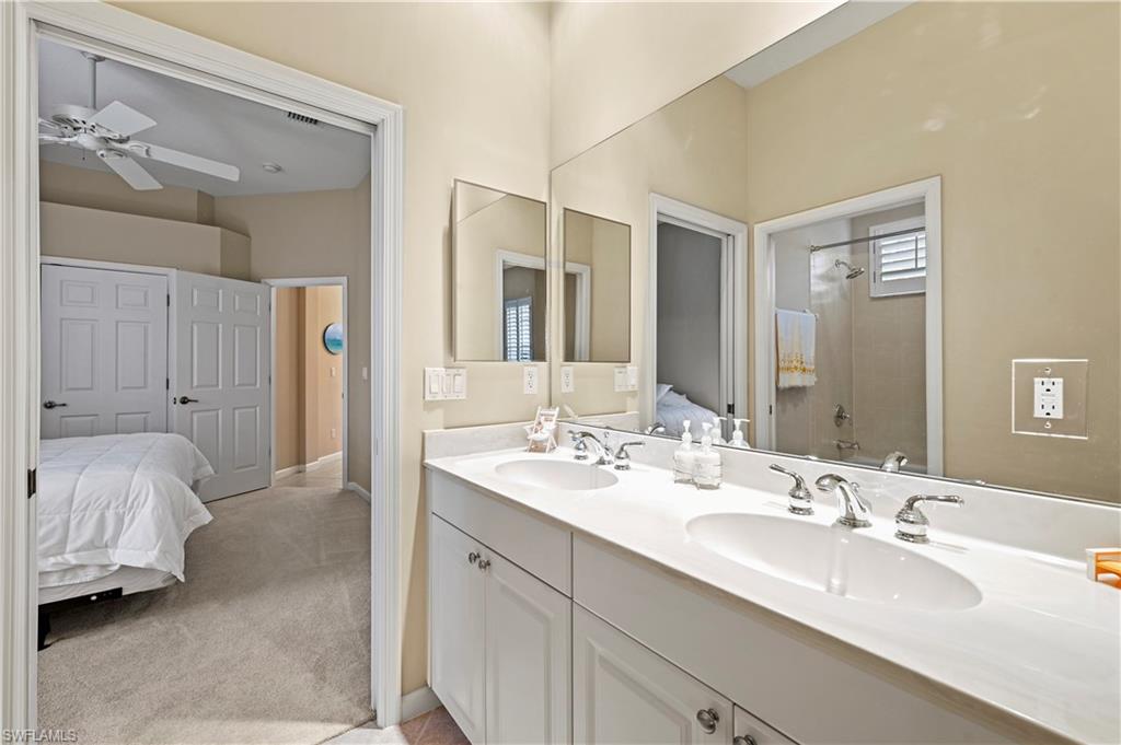 7950 Founders Circle Naples, FL 34104 - Photo 21 of 43 a en suite bathroom with double sink and a mirror