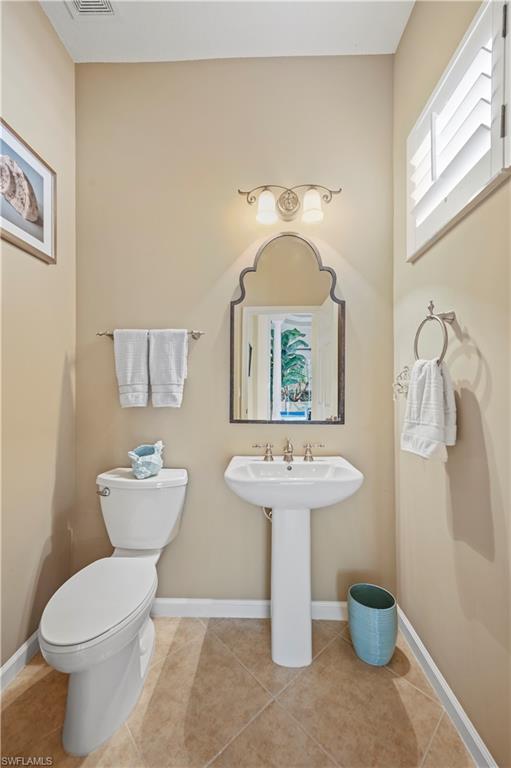 7950 Founders Circle Naples, FL 34104 - Photo 22 of 43 a bathroom with a toilet sink and mirror