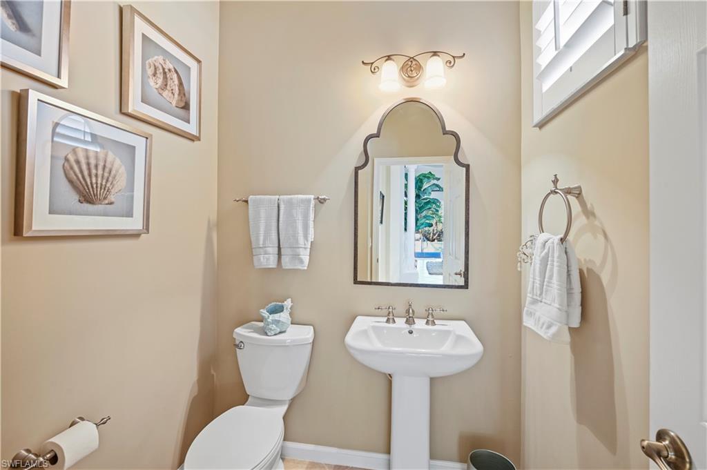 7950 Founders Circle Naples, FL 34104 - Photo 23 of 43 a bathroom with a toilet sink and mirror