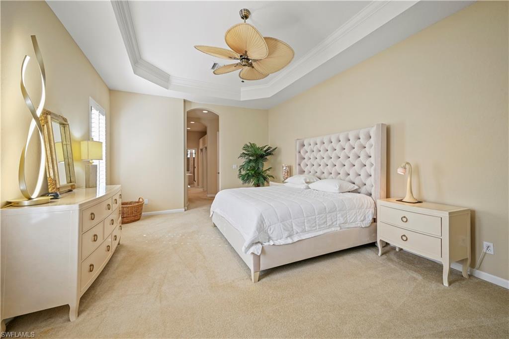 7950 Founders Circle Naples, FL 34104 - Photo 29 of 43 a bedroom with a bed and a chandelier