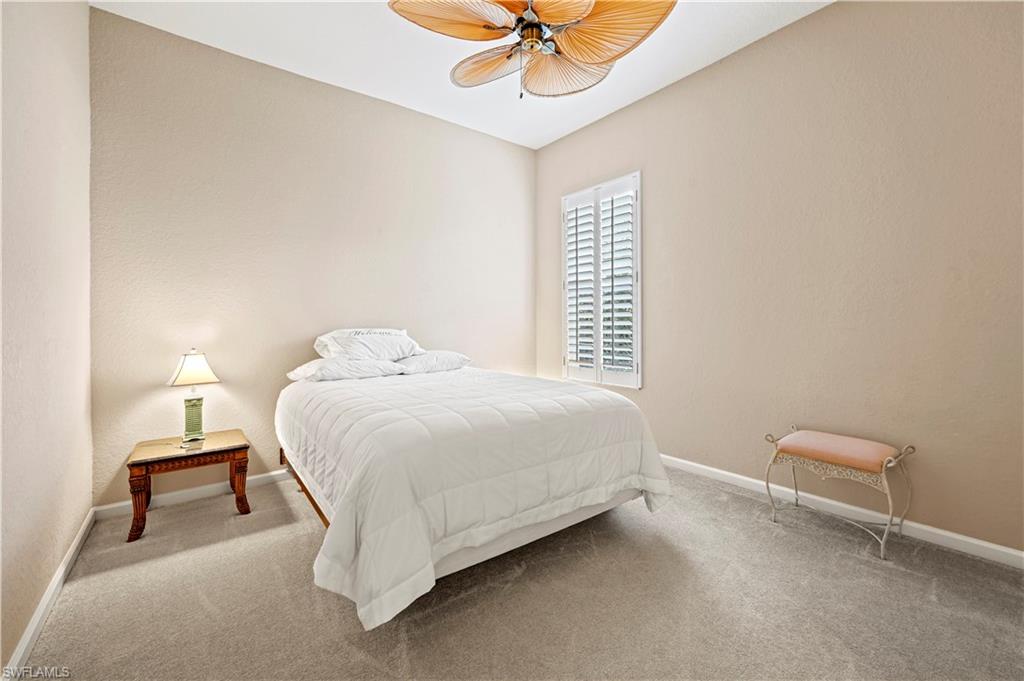 7950 Founders Circle Naples, FL 34104 - Photo 30 of 43 a bedroom with a bed and a chandelier