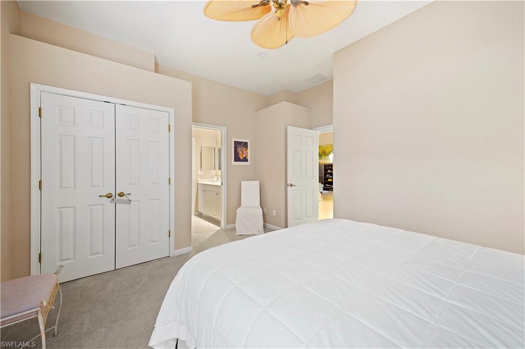 7950 Founders Circle Naples, FL 34104 - Photo 33 of 43 a bedroom with a bed and a chandelier