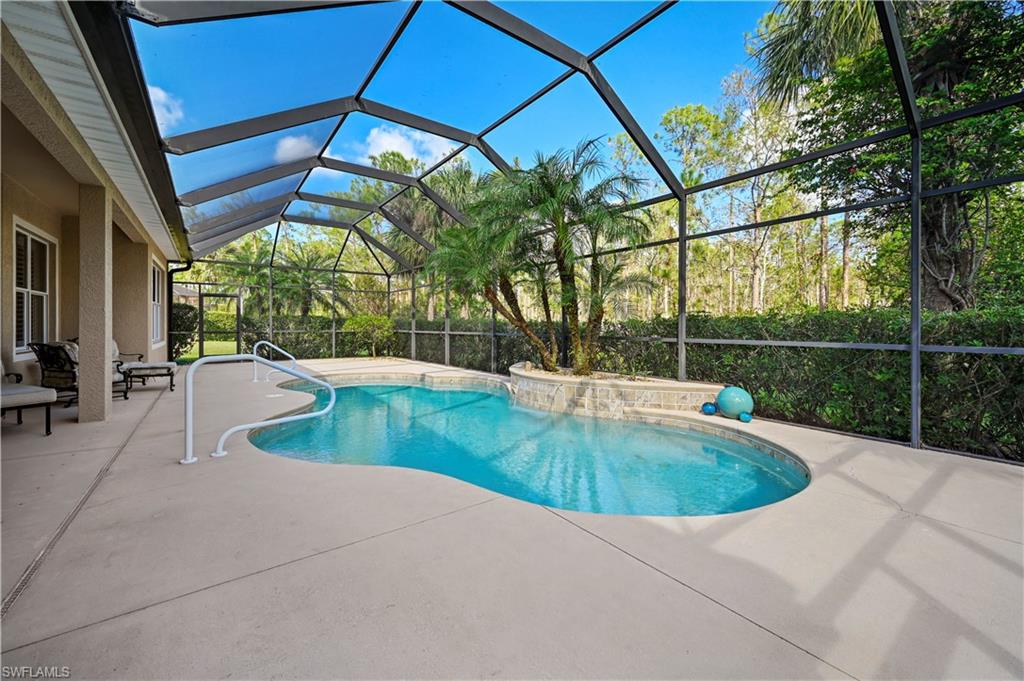 7950 Founders Circle Naples, FL 34104 - Photo 37 of 43 a view of backyard with swimming pool and outdoor seating