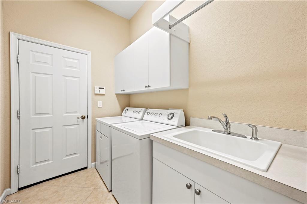 7950 Founders Circle Naples, FL 34104 - Photo 38 of 43 a utility room with dryer and washer