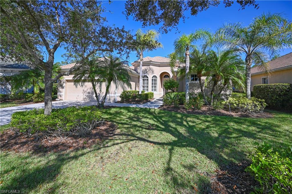 7950 Founders Circle Naples, FL 34104 - Photo 40 of 43 a front view of a house with garden