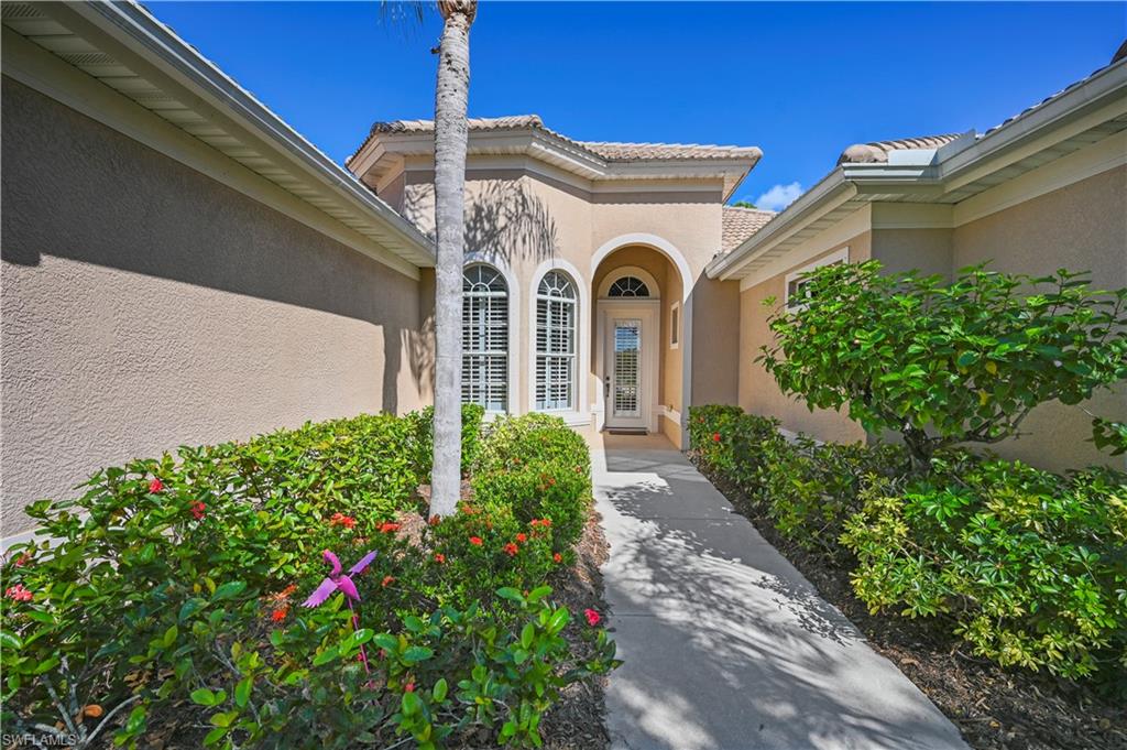7950 Founders Circle Naples, FL 34104 - Photo 4 of 43 a front view of a house with garden
