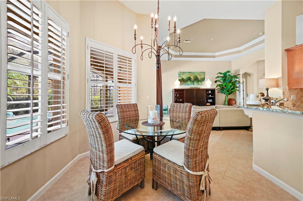 7950 Founders Circle Naples, FL 34104 - Photo 10 of 43 a view of a dining room with furniture and a chandelier