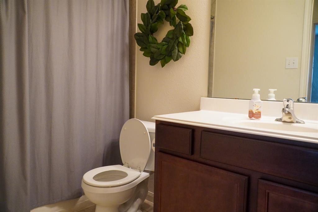 13624 Helix Bridge Way Crowley, TX 76036 - Photo 15 of 25 a bathroom with a sink a toilet and a mirror