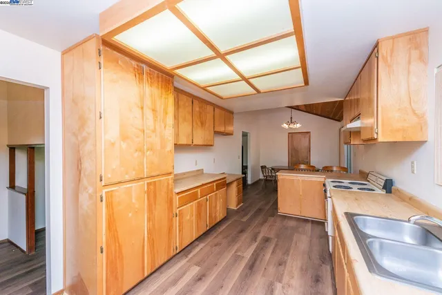 a kitchen with stainless steel appliances a stove a sink and a refrigerator