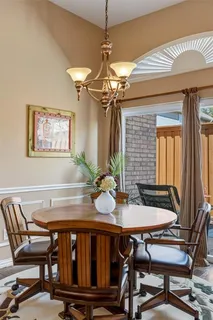 a view of a dining room with furniture and chandelier