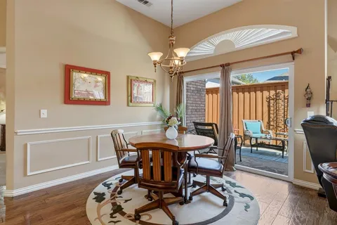 a view of a a dining room with furniture window and wooden floor