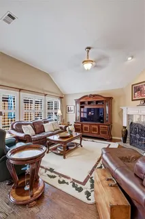 a living room with furniture a rug and a chandelier