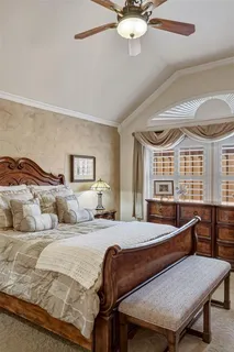 a bedroom with a bed a bed and a chandelier