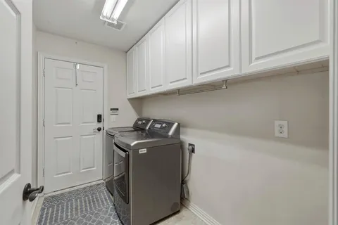 a utility room with cabinets