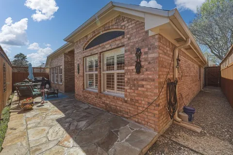 a backyard of a house with table and chairs