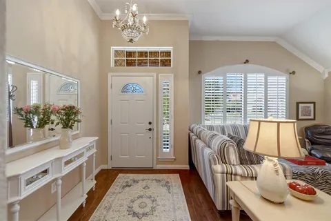 a living room with furniture and a chandelier