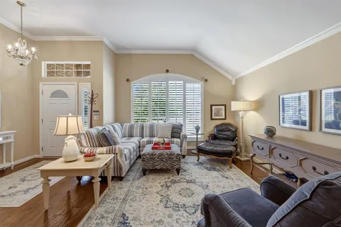 a bedroom with furniture and a large window