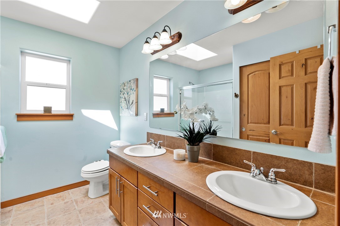 20815 9th Drive Southeast Bothell, WA 98021 - Photo 14 of 23 a bathroom with a granite countertop sink a toilet and a mirror