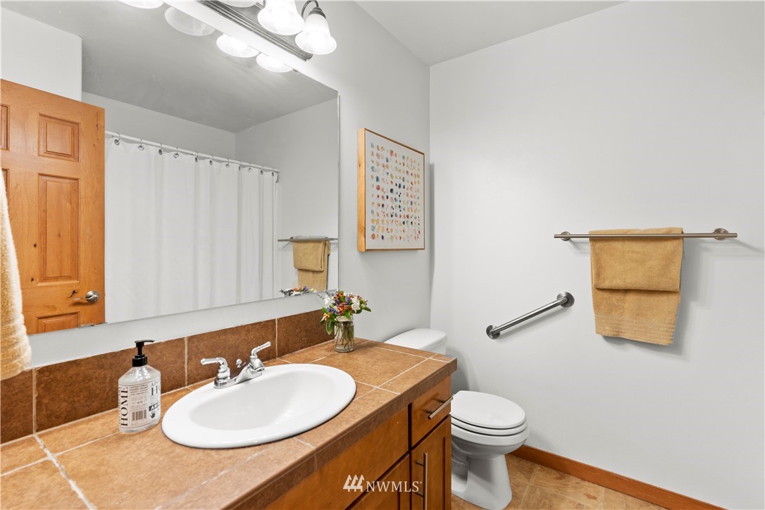 20815 9th Drive Southeast Bothell, WA 98021 - Photo 18 of 23 a bathroom with a toilet sink and mirror