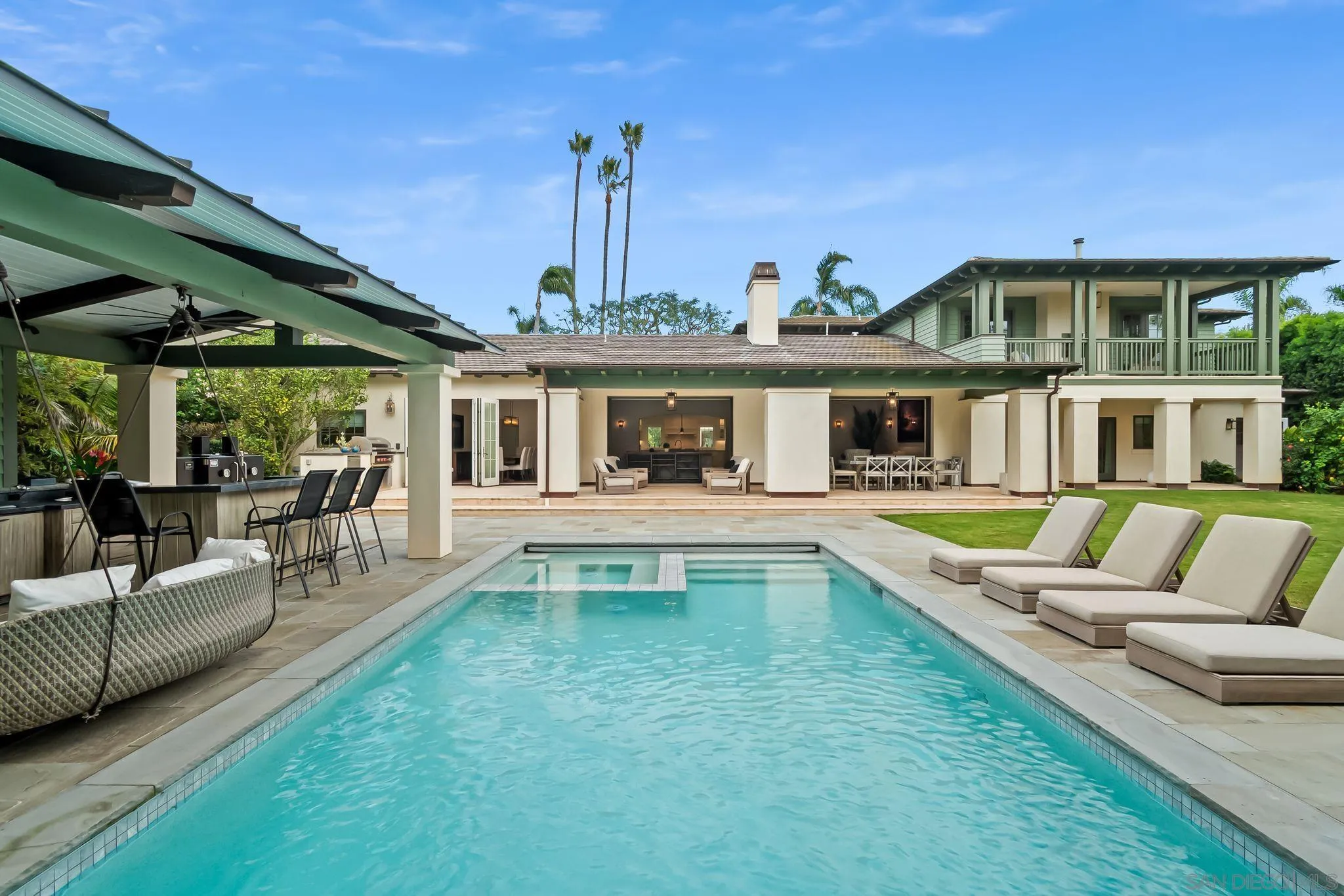 a view of house with swimming pool outdoor seating