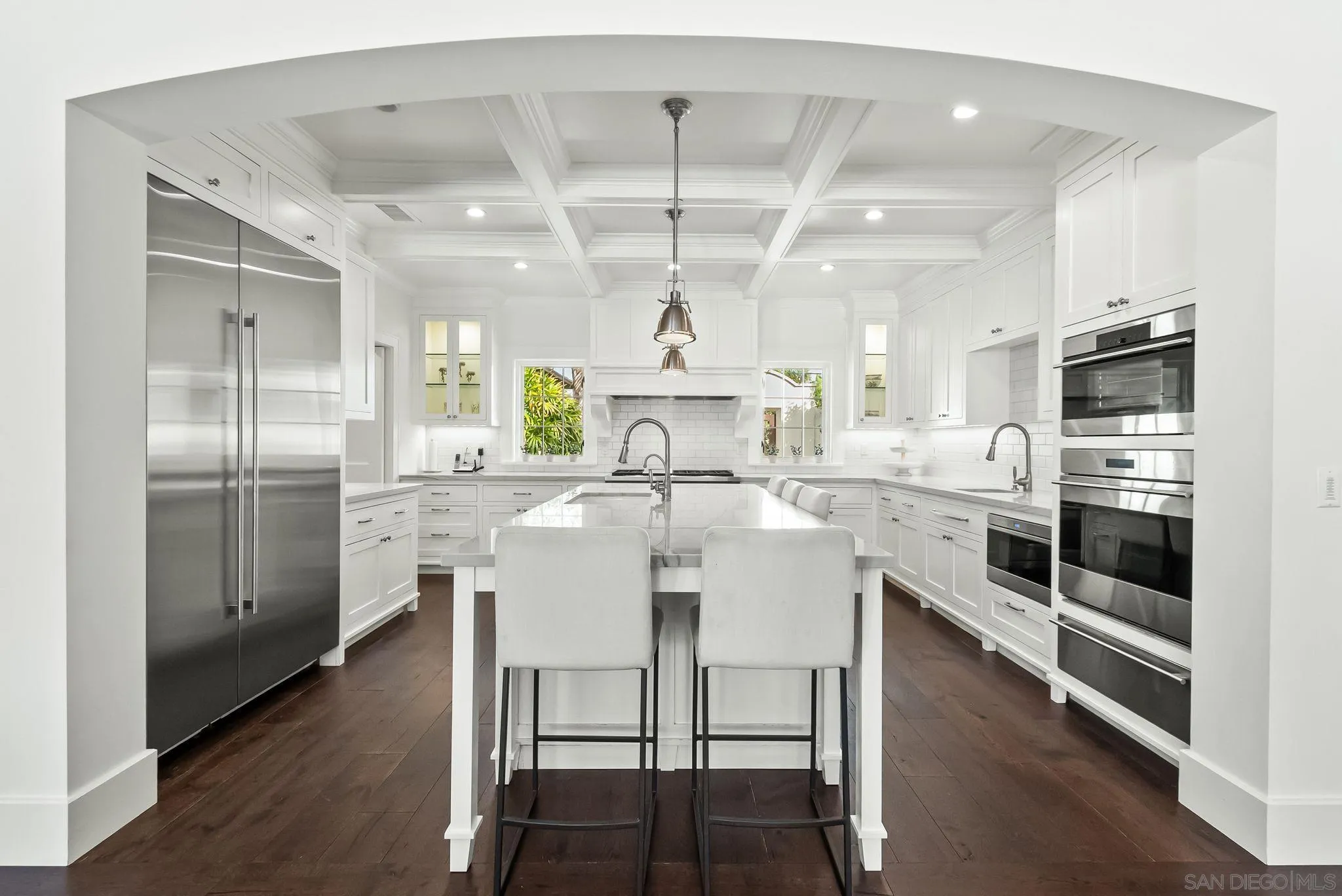 5930 Rutgers Road La Jolla, CA 92037 - Photo 11 of 43 a kitchen with stainless steel appliances a refrigerator a stove a sink dishwasher and white cabinets with wooden floor