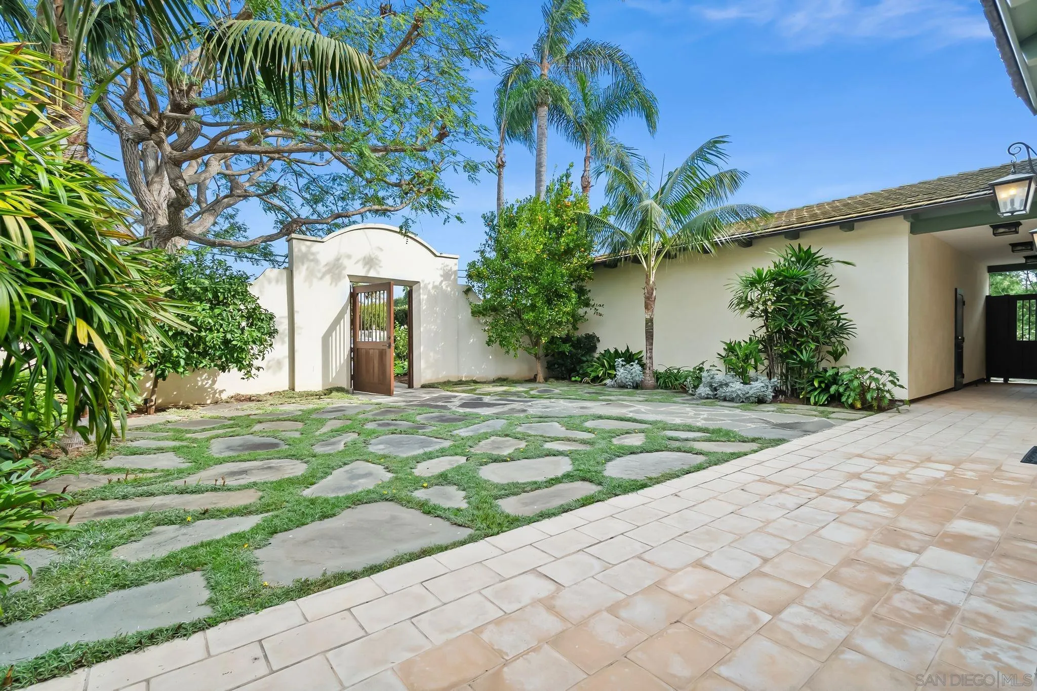 5930 Rutgers Road La Jolla, CA 92037 - Photo 7 of 43 a view of a white house with a yard and potted plants