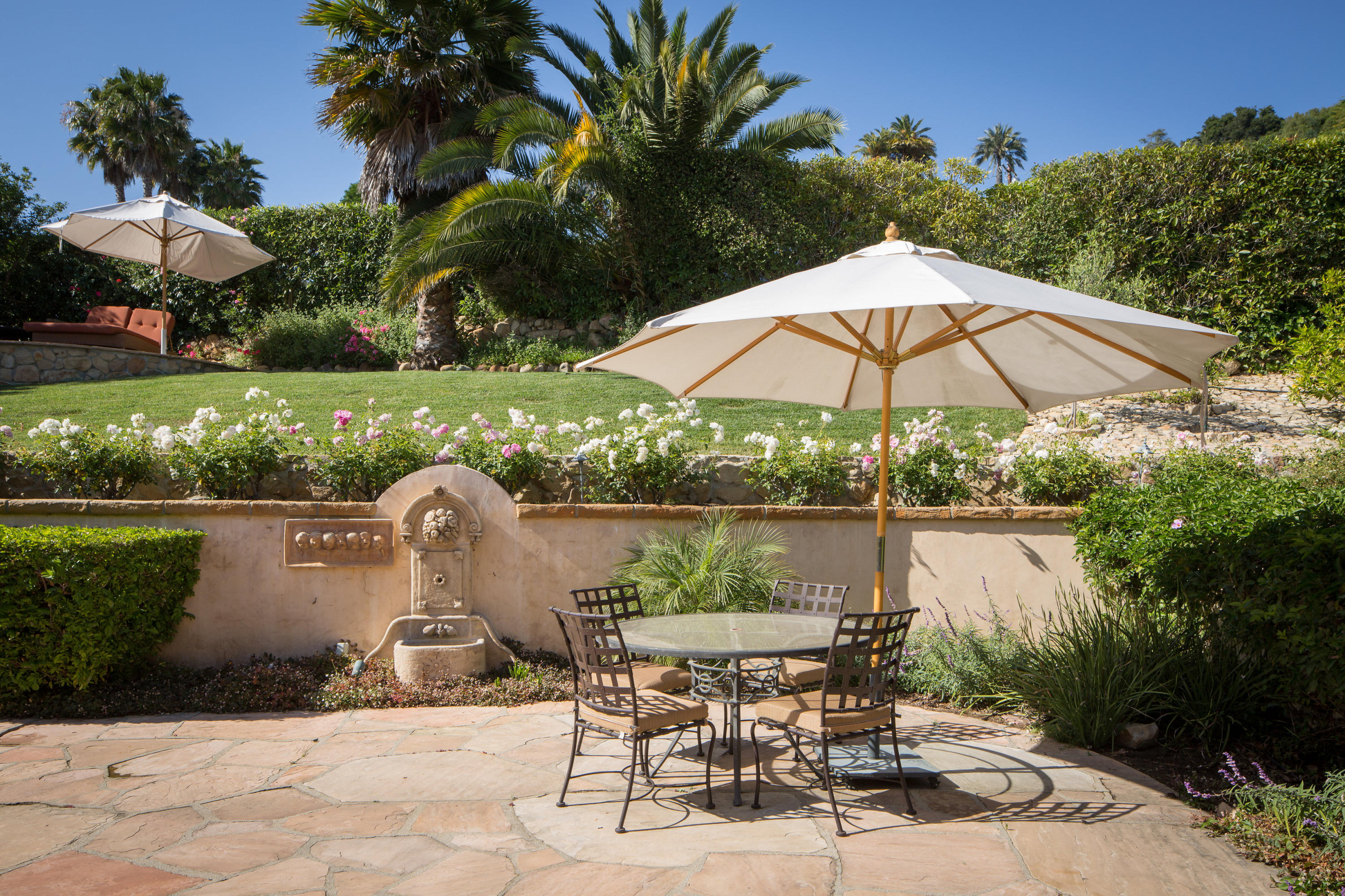 1810 Mission Ridge Road Santa Barbara, CA 93103 - Photo 21 of 30 a view of a lake with table and chairs under an umbrella