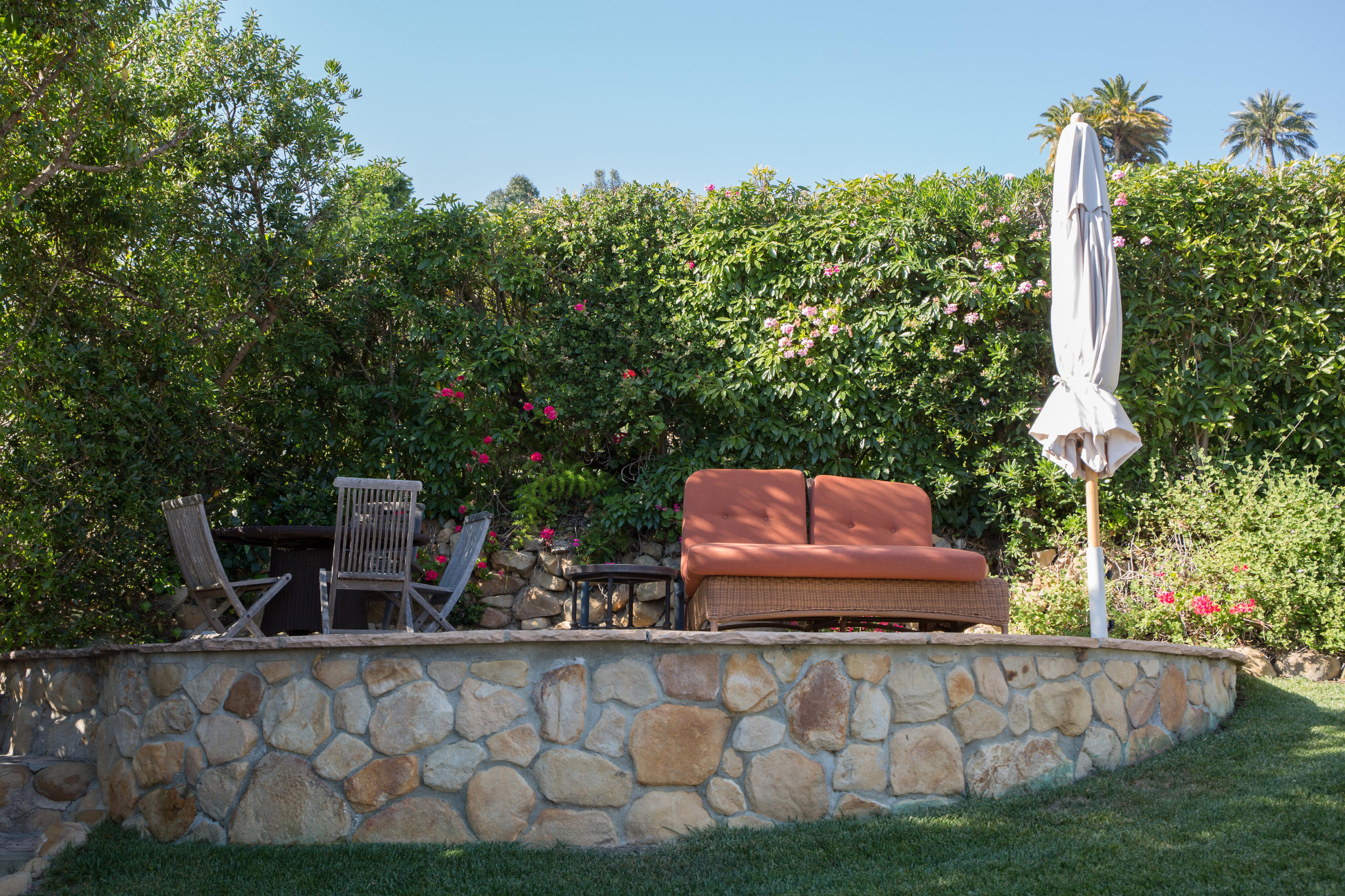 1810 Mission Ridge Road Santa Barbara, CA 93103 - Photo 24 of 30 a wooden bench sitting in the middle of a yard
