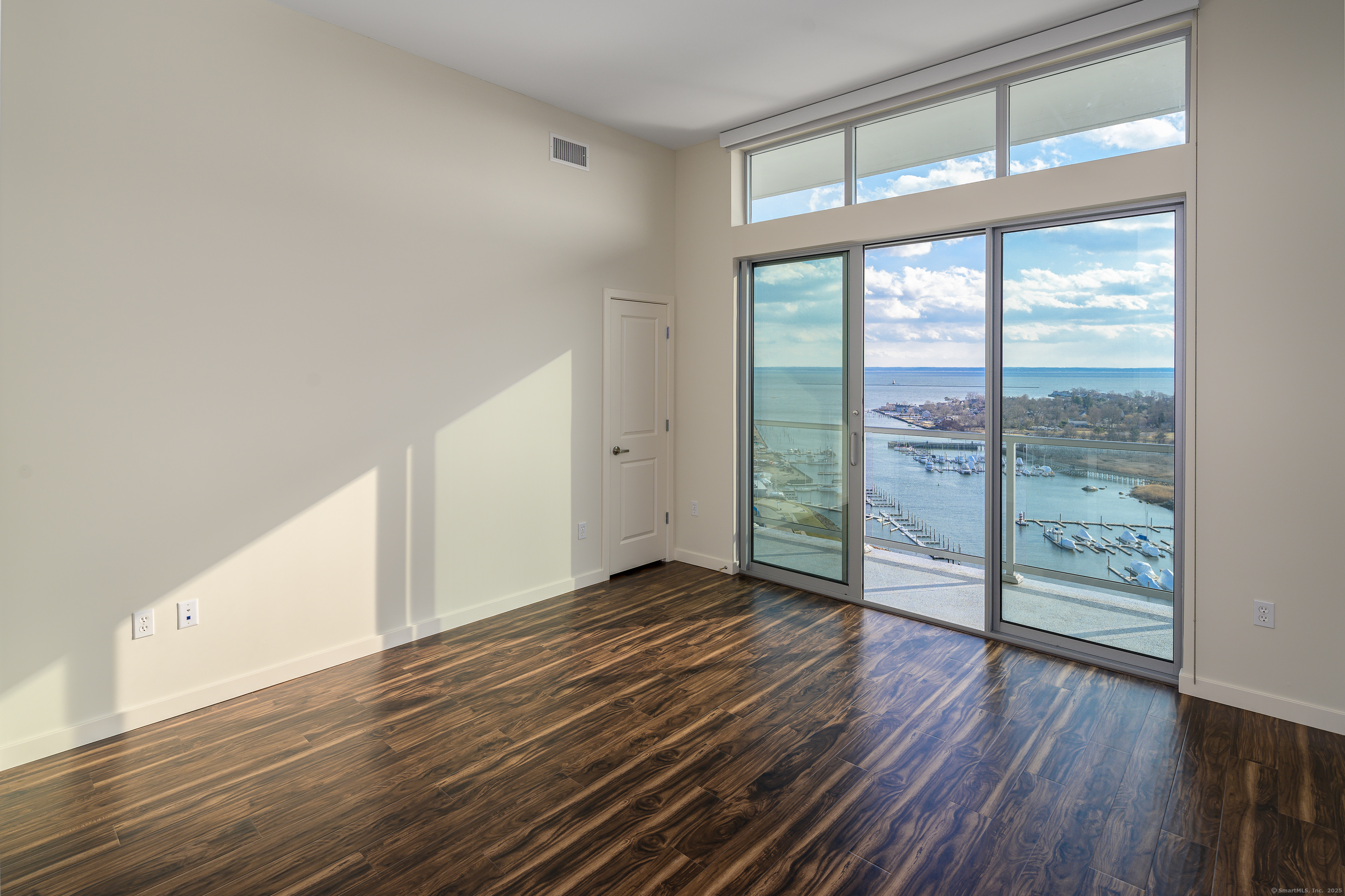 1 Harbor Point Road, Unit 1 Stamford, CT 06902 - Photo 11 of 23 wooden floor in an empty room with a window