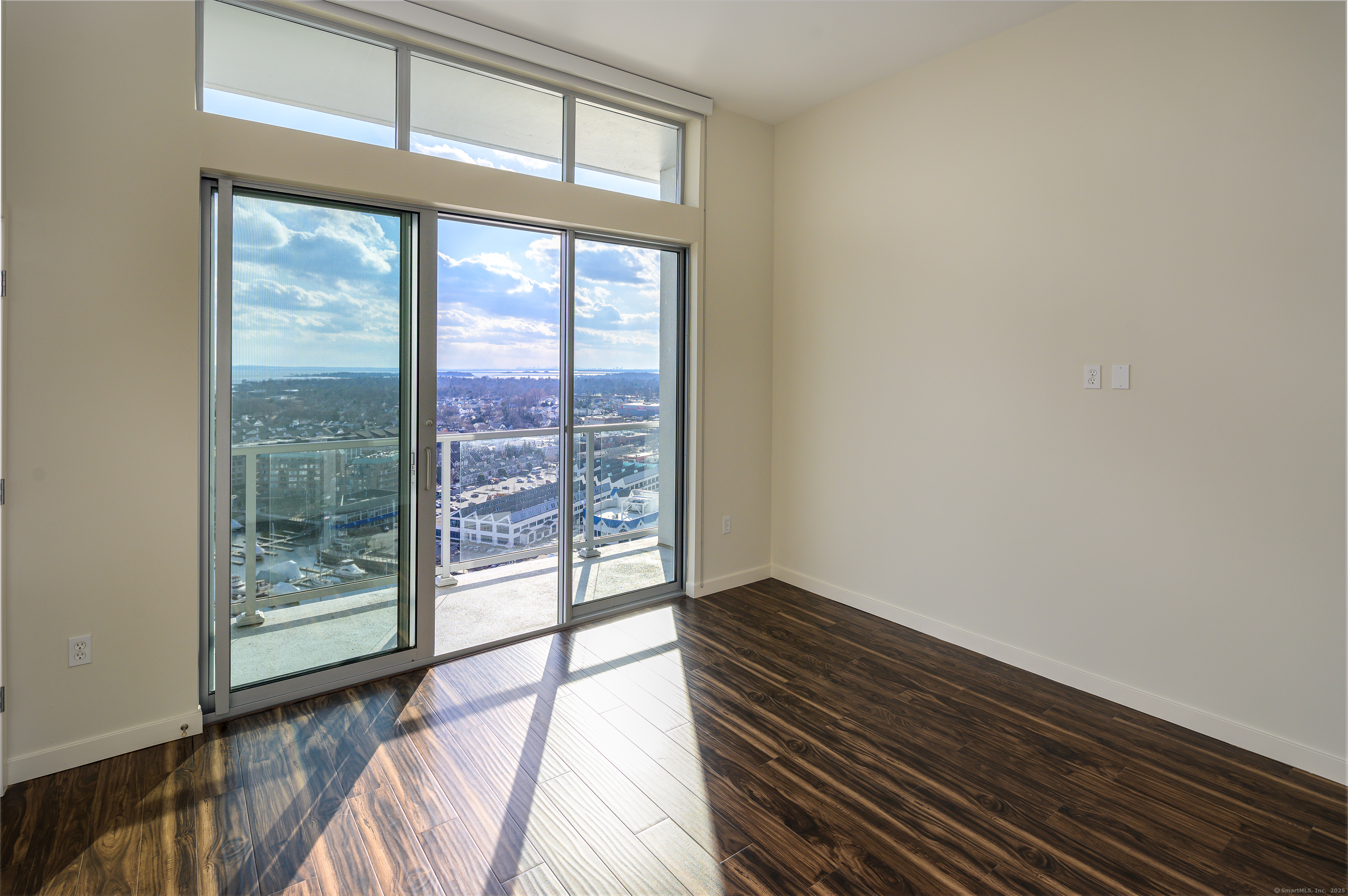 1 Harbor Point Road, Unit 1 Stamford, CT 06902 - Photo 13 of 23 a view of room with window and wooden floor